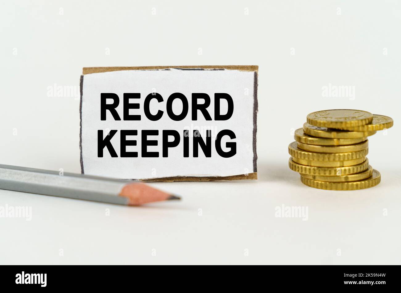 Valuable Keeping Sign Business concept. On a white background, a pencil, coins and a sign ...