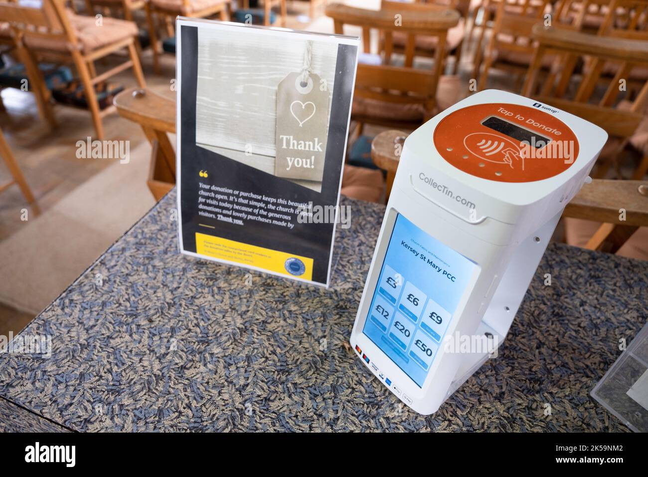 Contactless device to donate digitally in St Mary's Church in Kersey, Suffolk. Tap to give. Narrow depth of field, focus on the numbers Stock Photo