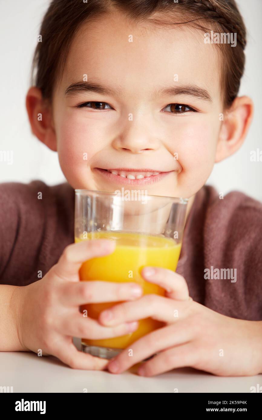 Freshly squeezed orange juice. Closeup of an adorable little girl