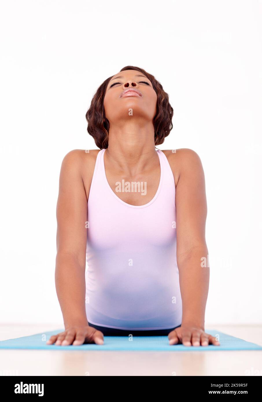 Feeling her stress wash away. A young african-american woman performing a yoga routine. Stock Photo