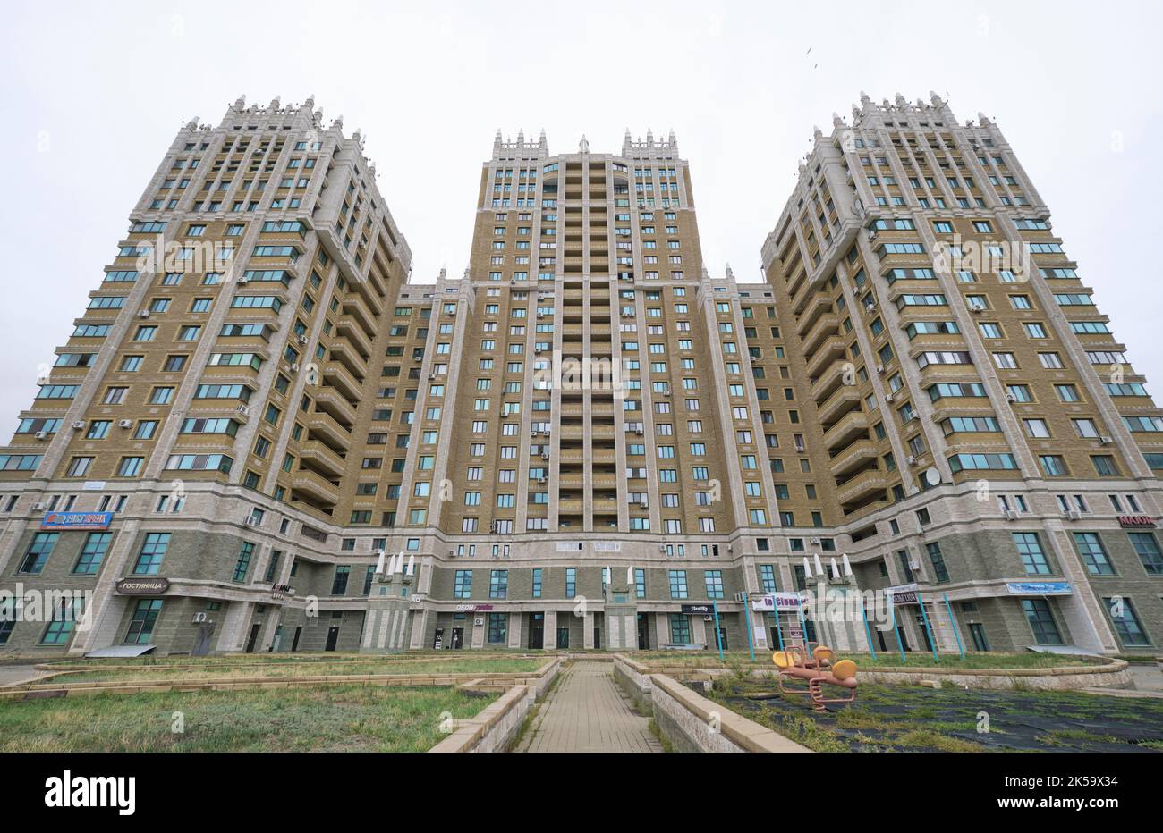 Cloudy, grey view of the looming, iconic Triumph Towers, modeled after
