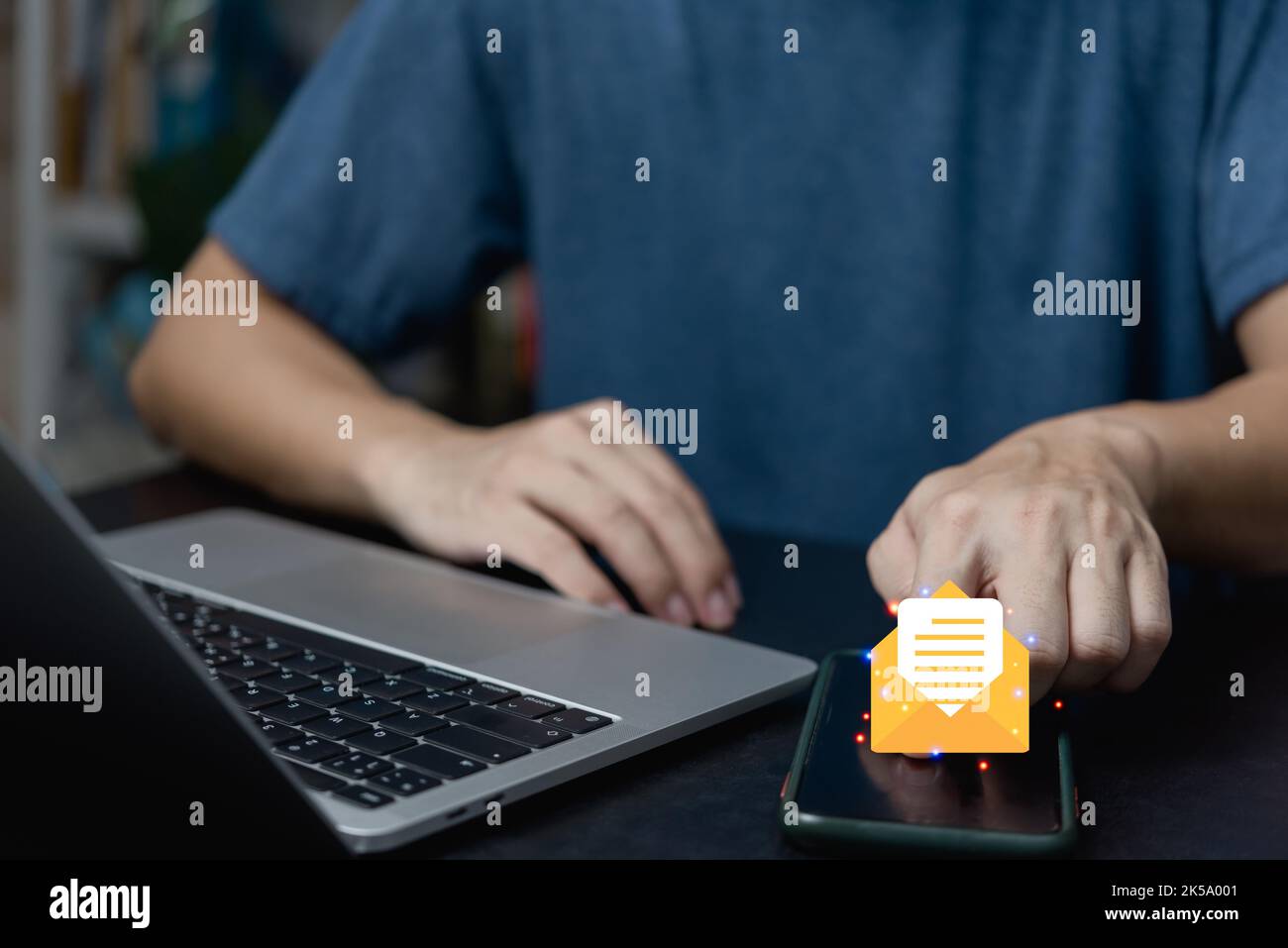 businessman holding hand touchscreen smartphone and checking email icon online or sending mail to partner and customer on web with virtual interface t Stock Photo
