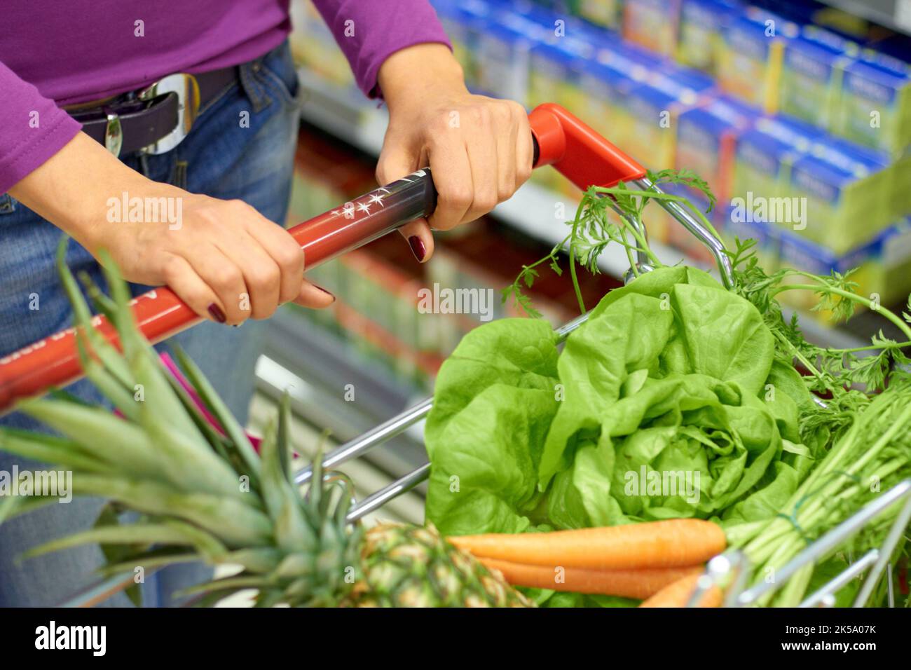 Healthy choice for the pantry. a woman pushing a shopping cart with