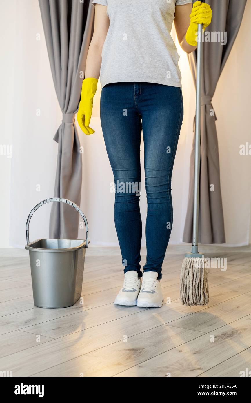 Fluid cleaning. Housework routine. Home hygiene. Woman in jeans tshirt