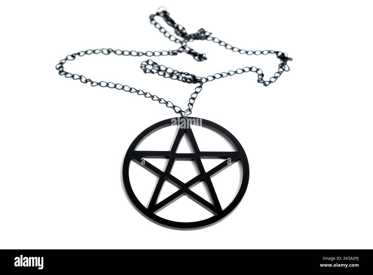 Close-up of a large black pentagram necklace isolated on white background Stock Photo