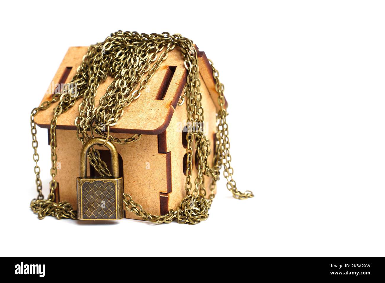 Primitive home security system concept wooden house wrapped in chains