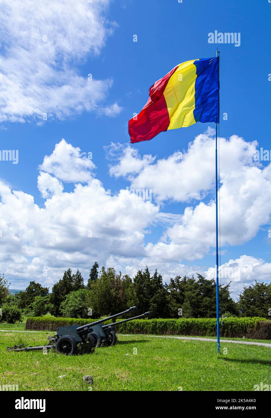 Romanian flag and Cannons placed at the monument to Romanian heroes of World War II on may 30, 2021 in Oarba de Mures, Transylvania Stock Photo
