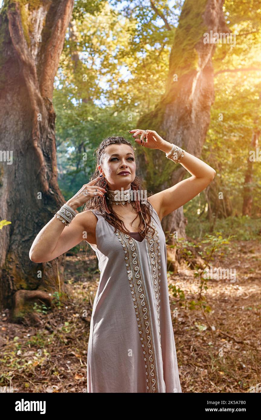girl in a dress walks in a mysterious forest Stock Photo - Alamy