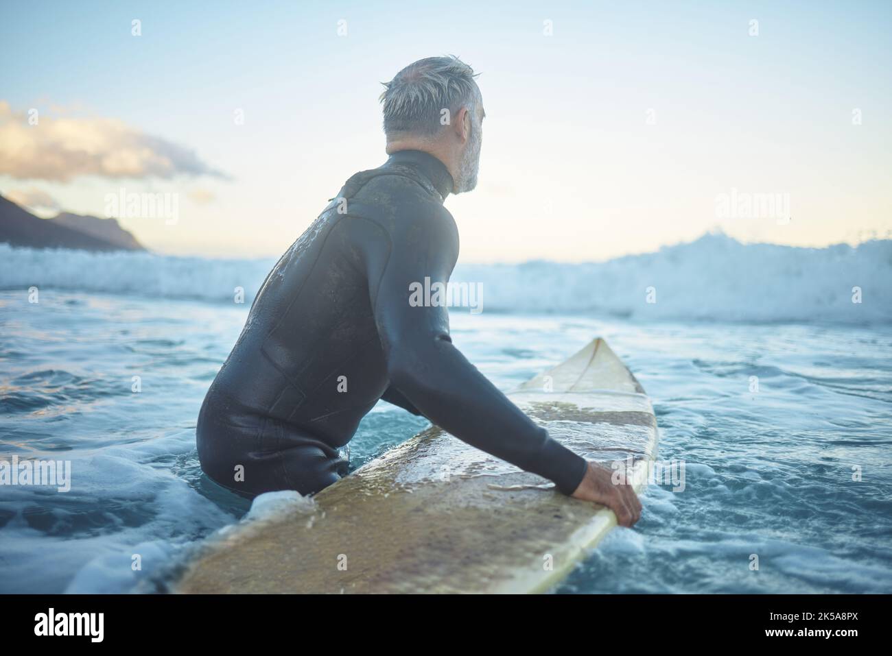 Senior man surfing in sea ocean, water waves in Australia sky and