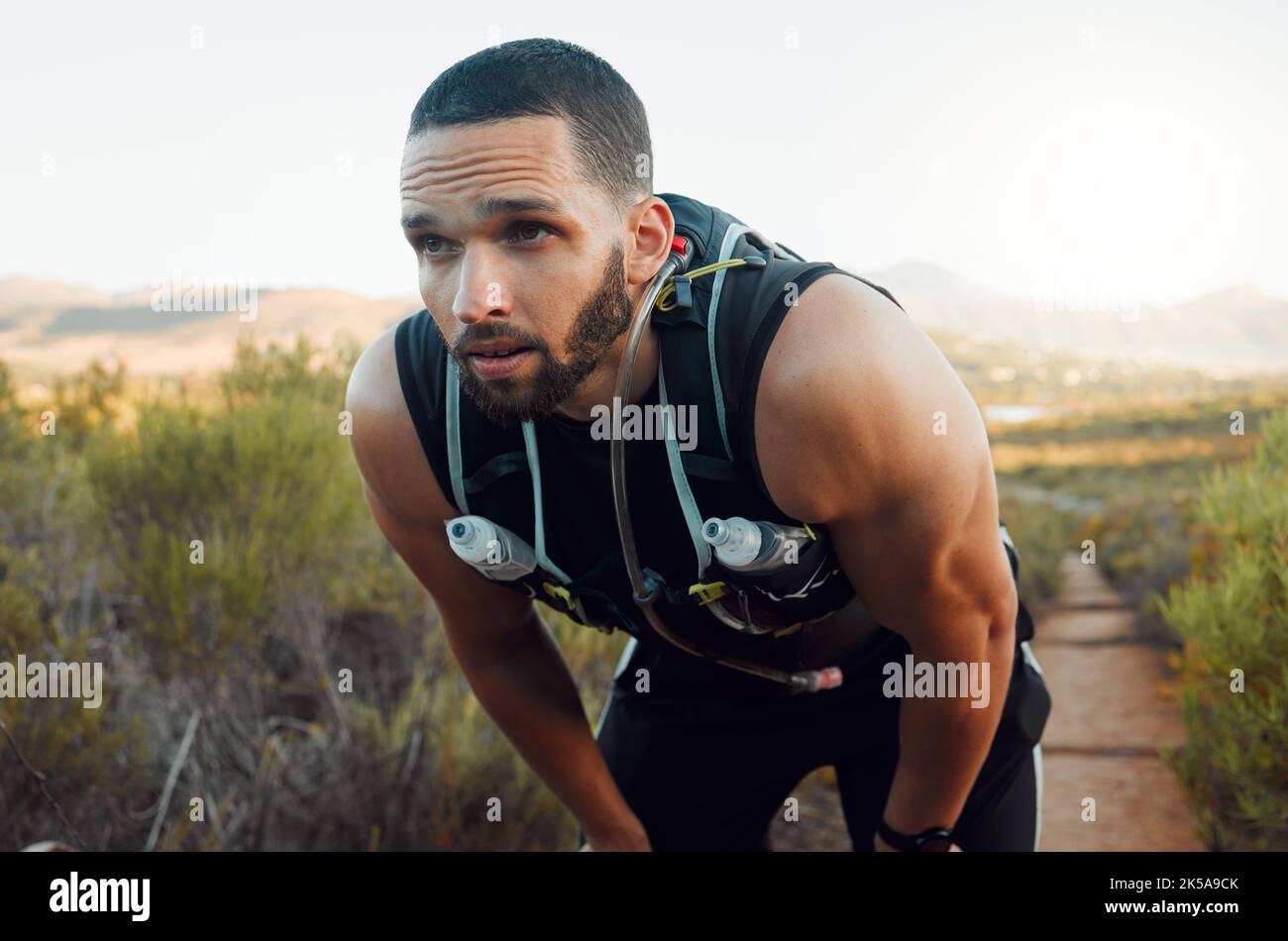 Sweating, breathing and tired fitness man running outdoors with fatigue, body challenge and struggle for exercise. Male runner athlete, mental break Stock Photo