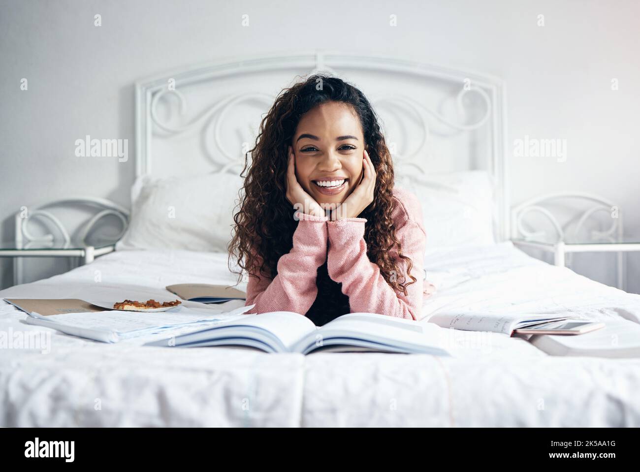 Student books and bed with black woman learning and studying in a