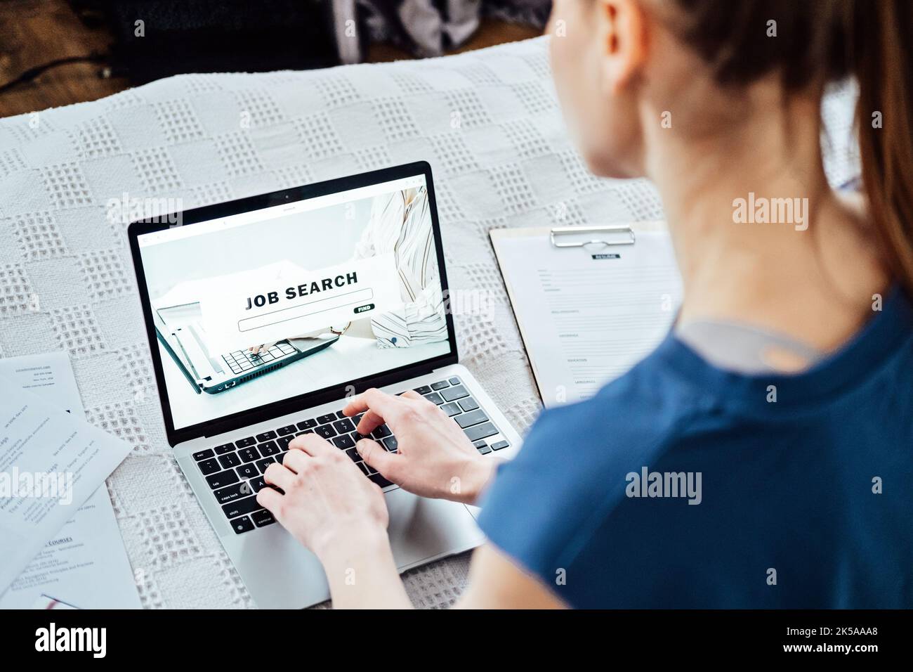 Job Search Career Recruitment Hiring Website Concept. Young woman in home browsing work opportunities online using job search web sites and Stock Photo