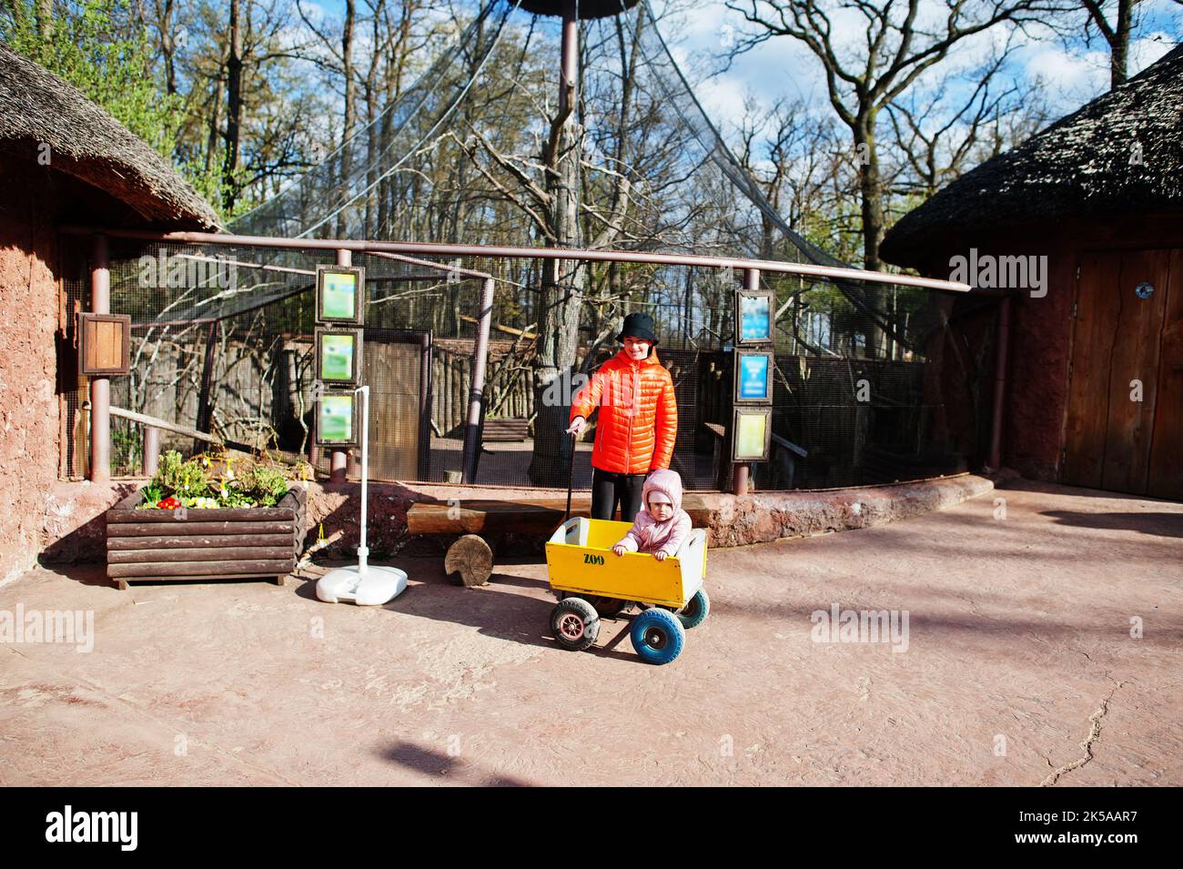 Boy pulls wooden trolley with sister at zoo Stock Photo Alamy