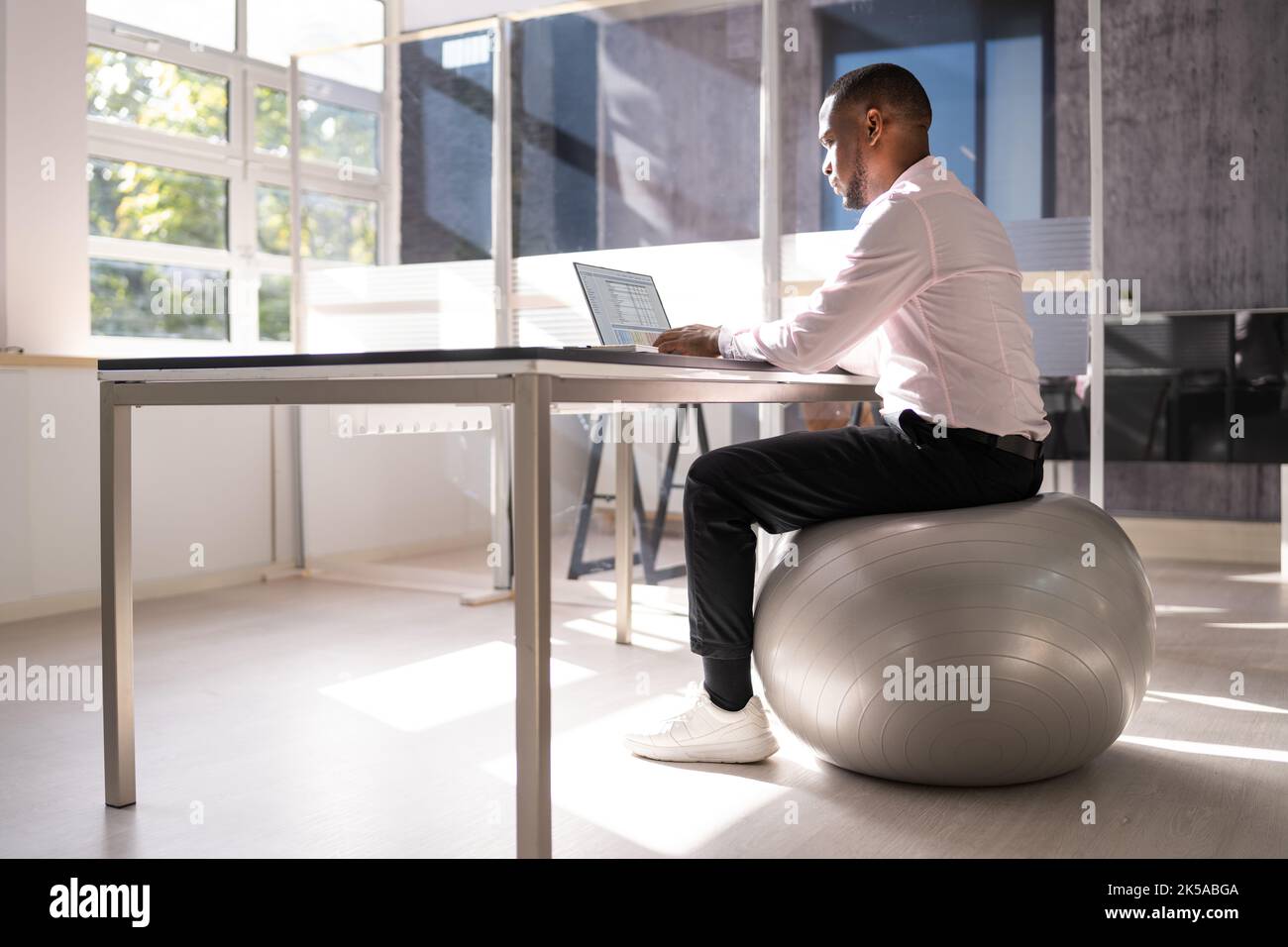 Correct Posture At Desk In Office Using Fitness Ball Stock Photo Alamy