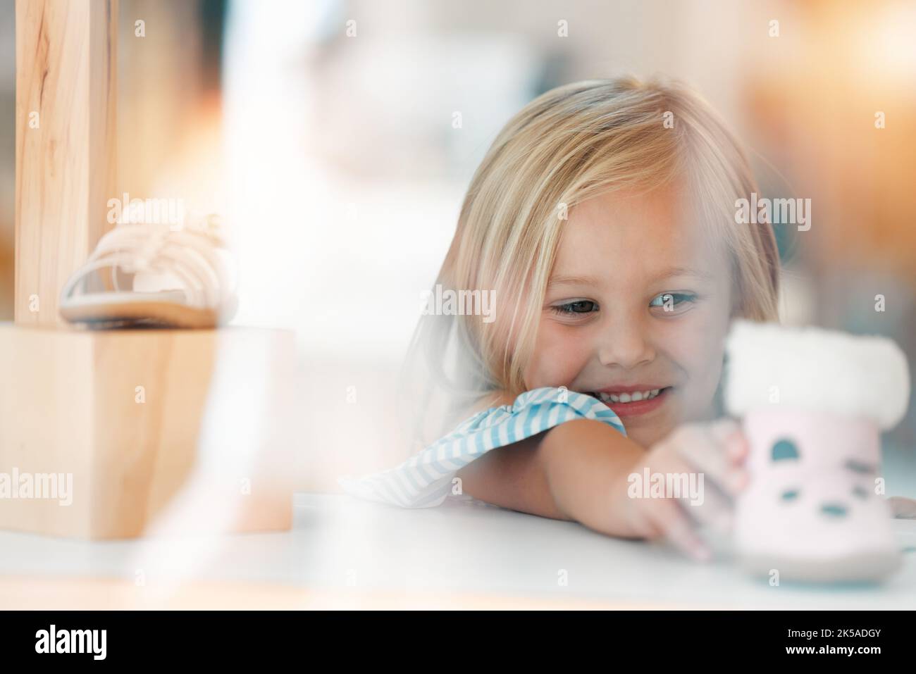 Happy Fashion And Child Shopping For Shoes At A Kids Clothing Store Or Happy fashion and child shopping for shoes at a kids clothing store or