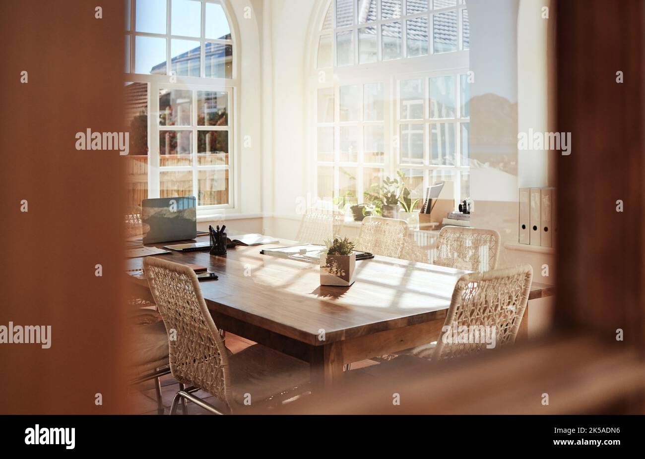 Interior, room and design with an empty home office in an office of a modern workplace during the day. Building, architecture and table in a corporate Stock Photo
