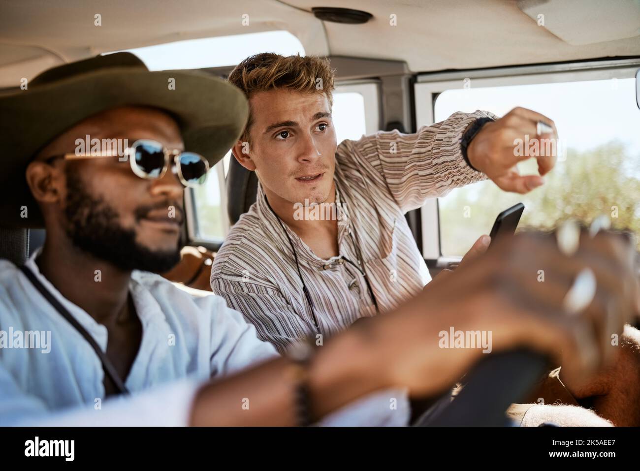 Travel, pointing and diversity friends in car for road trip, fun ...