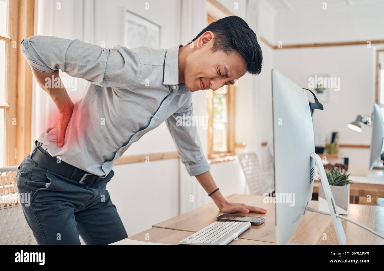 Businessman with back pain, muscle injury and burnout at office desk