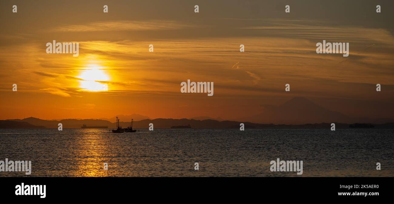 Fishing vessel in sunset with Fuji in background Stock Photo