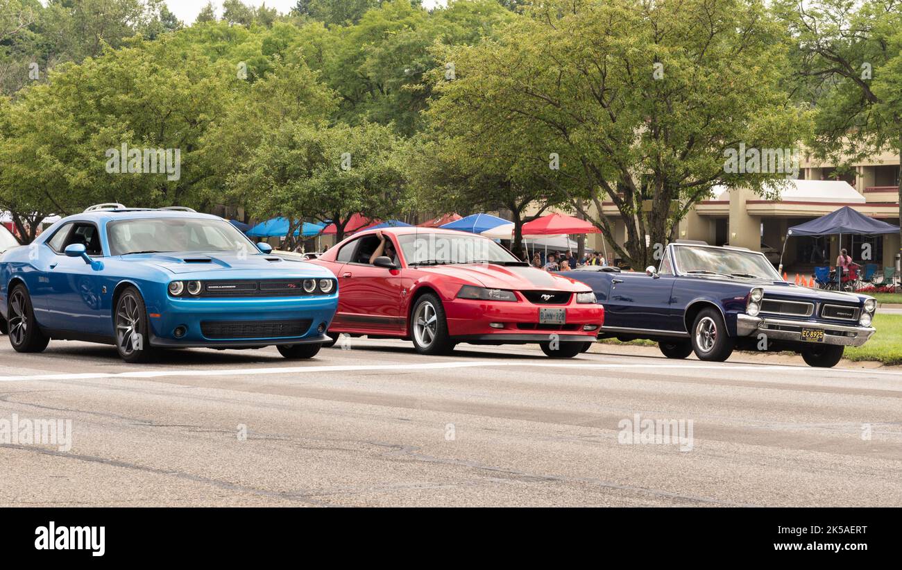 BLOOMFIELD HILLS, MI/USA - AUGUST 20, 2016: 'Face-off': 3rd generation Dodge Challenger, 4th generation Ford Mustang, 1st generation 1965 Pontiac GTO Stock Photo