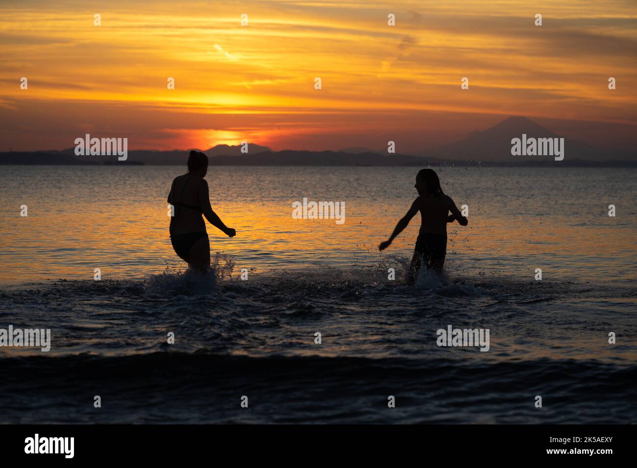 A couple having fun during sunset with Fuji in the background Stock Photo