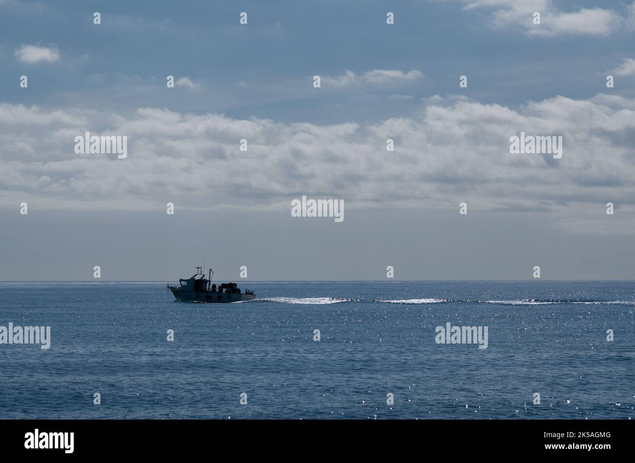Fisherman boat sailing across the sea quickly Stock Photo - Alamy