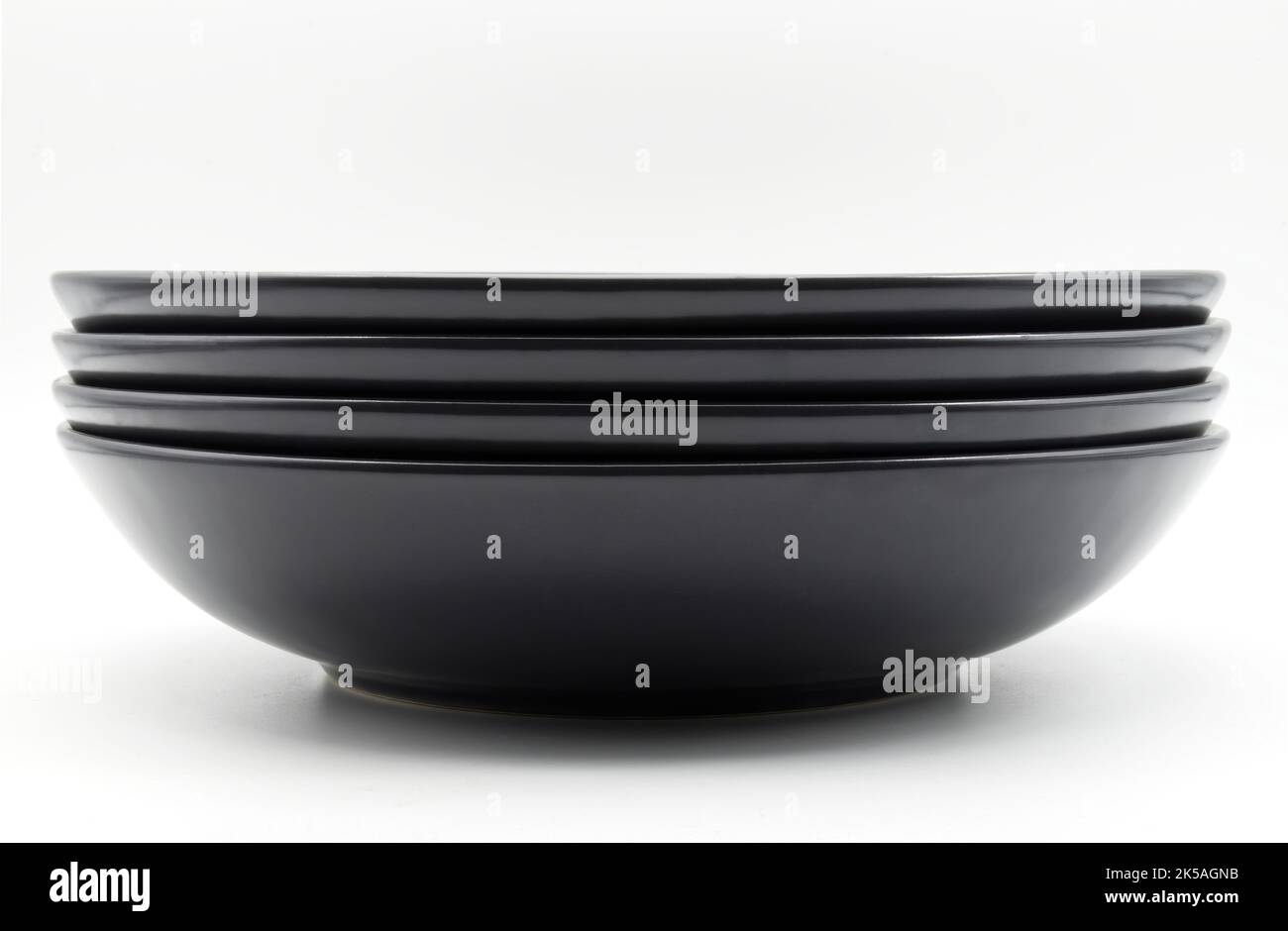 Stack of black dishes isolated on white background Stock Photo Alamy