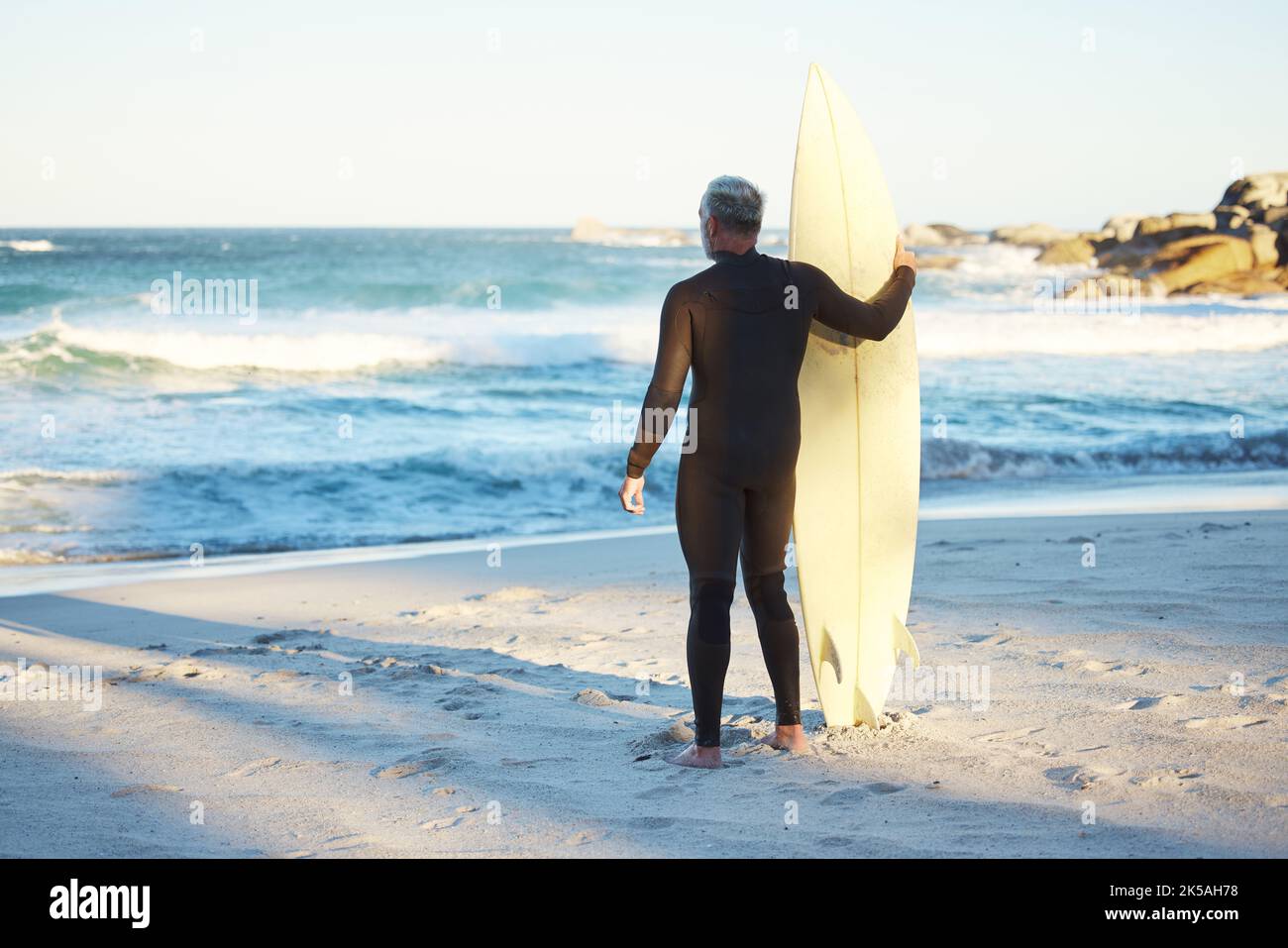 Surf, sport and sea with a man on the beach for fitness, exercise or ...