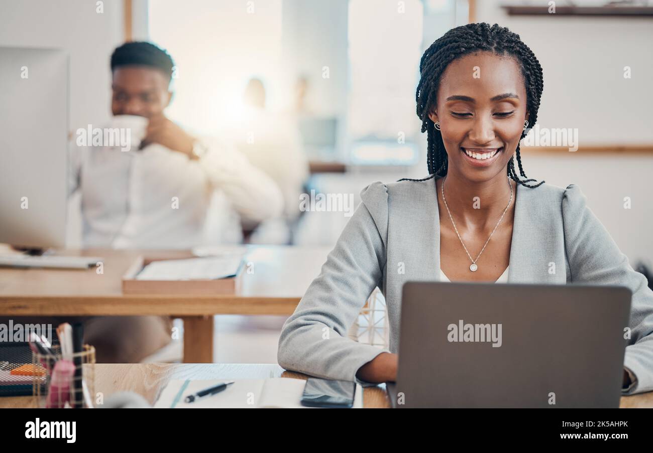 Email, corporate and black woman typing a proposal on the internet on a laptop in an office at work. African employee working on the web and planning Stock Photo