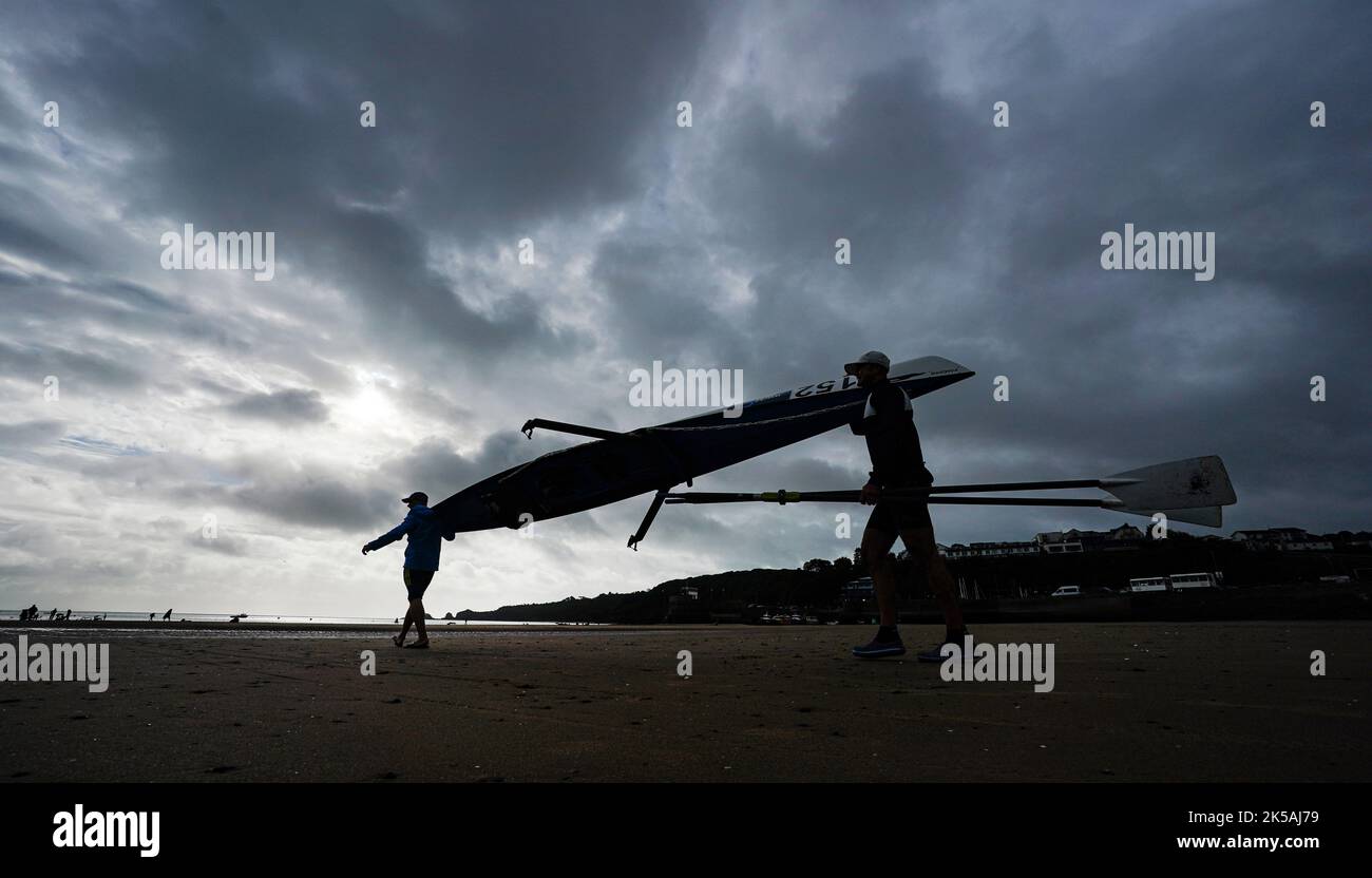 Rowers carry their boat to the sea during the World Rowing Championships and Beach Sprint, at Saundersfoot, Wales. Picture date: Friday October 7, 2022. Stock Photo