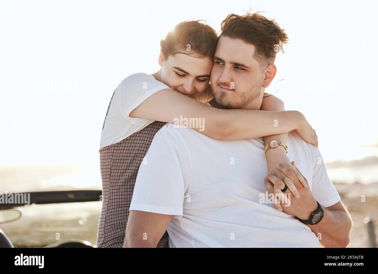 Real couple hug, road trip and relax at sunset on a romantic driving vacation in Costa Rica together. Happy white man, woman travel the country in a Stock Photo