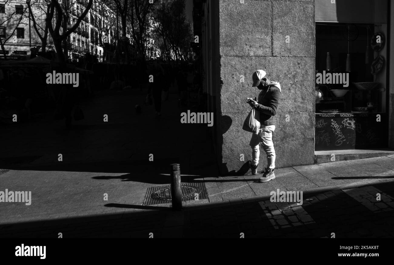 Unrecognizable man standing outdoors on city street. Black and white photography. Stock Photo