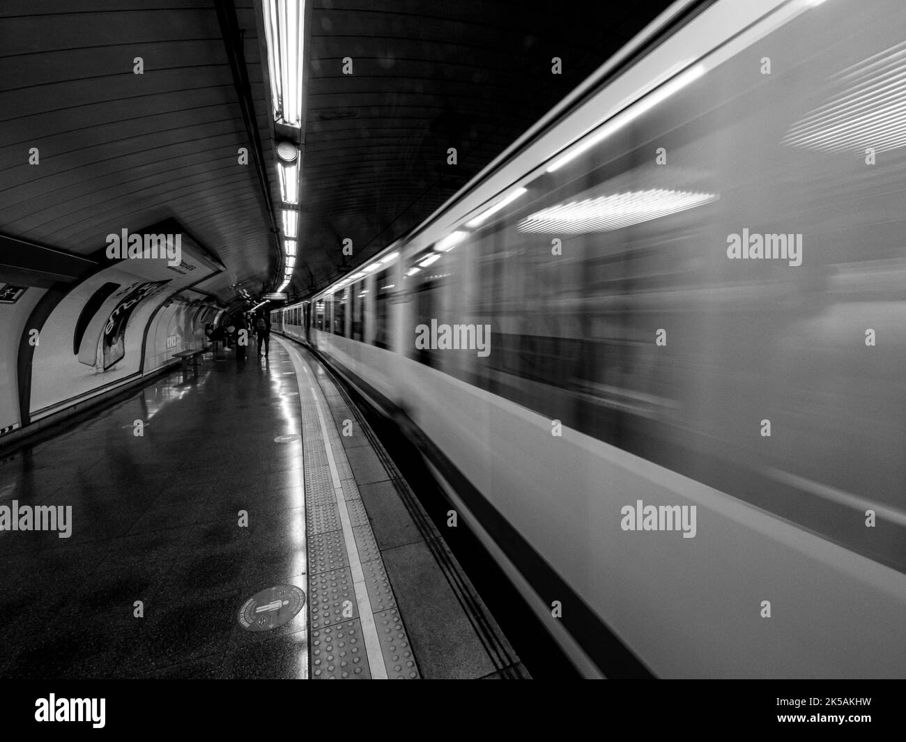 Black and white photograph of the subway train leaving the station. Transportation concept. Stock Photo