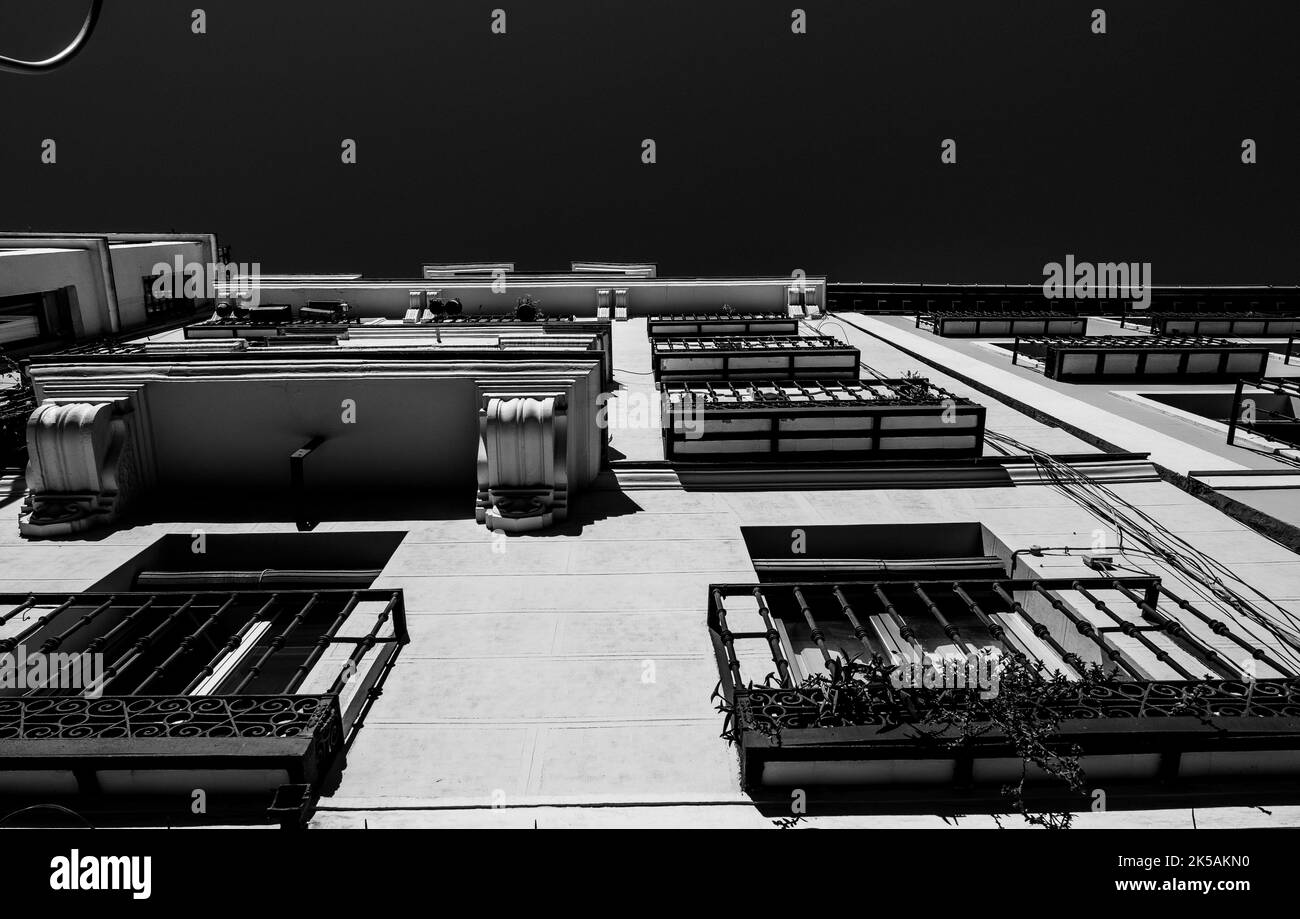 Low angle view of the facade of old residential apartment buildings. Black and white photography. Stock Photo