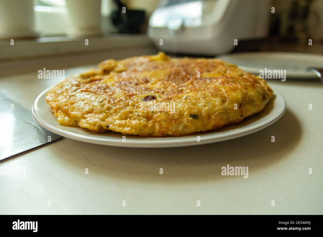 Traditional Spanish tortilla on a plate, prepared at home Stock Photo