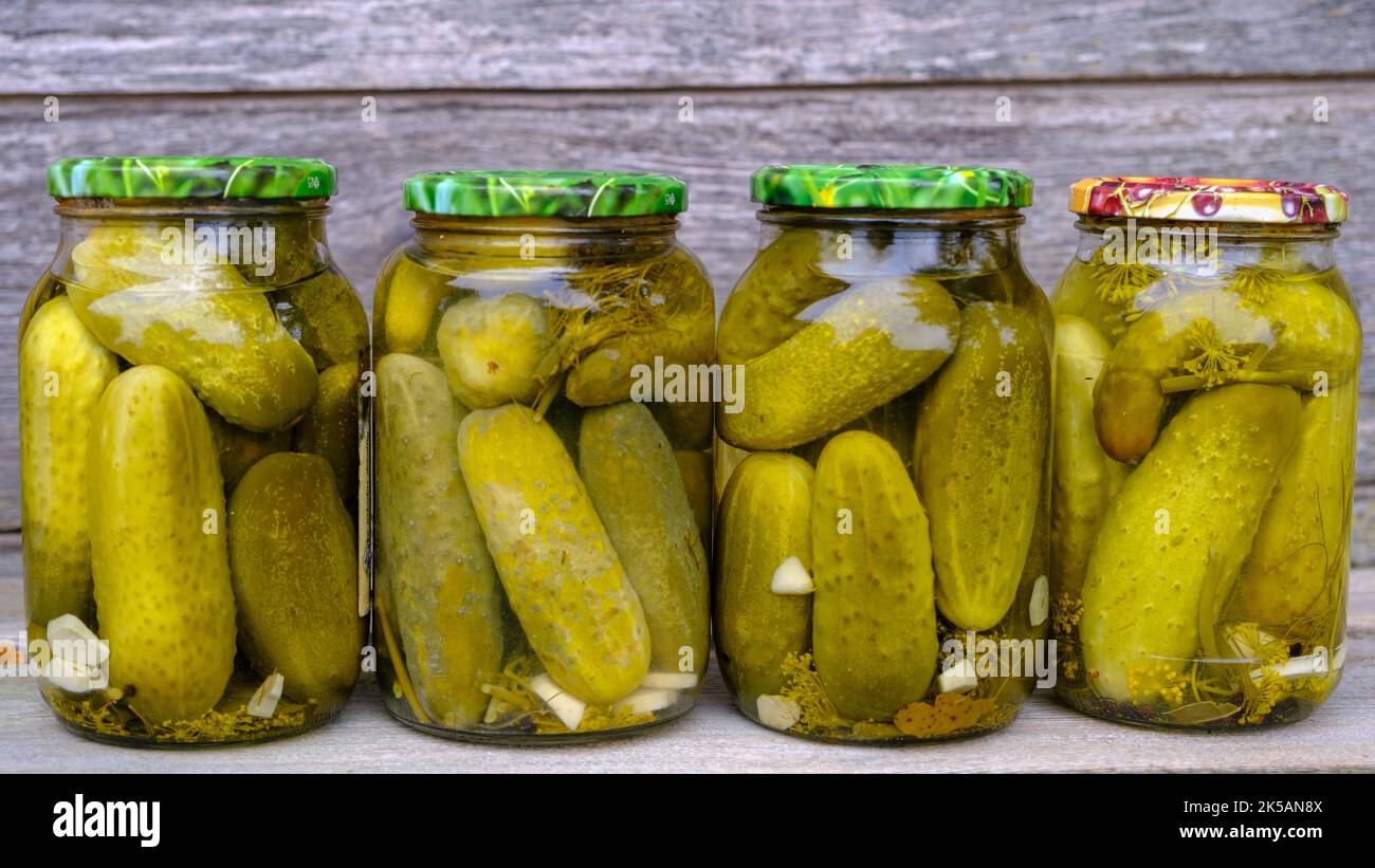 Glass jars with pickled cucumbers. Jars with various pickled vegetables