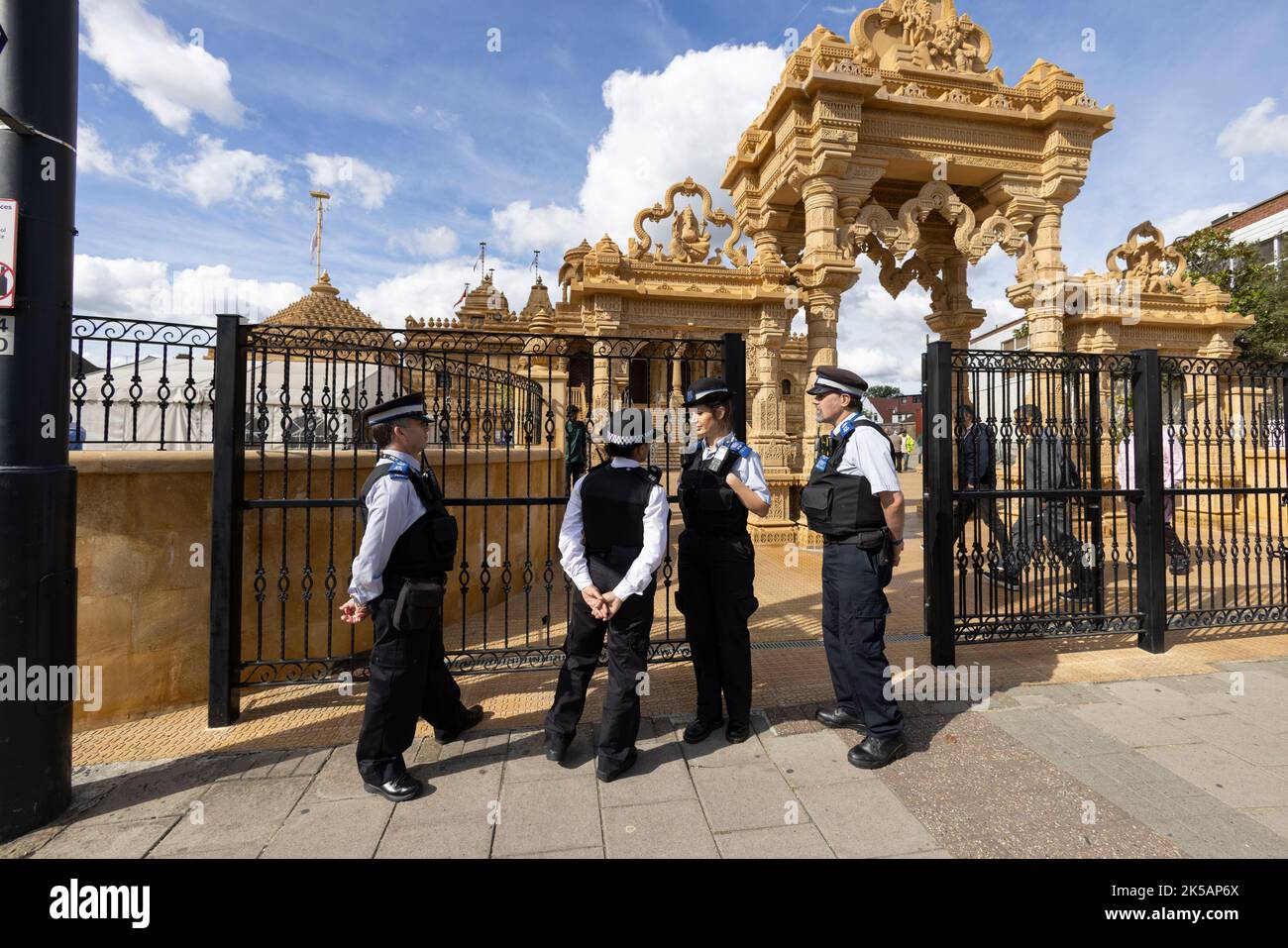 Metropolitan Police keep an eye outside the Shree Santa Hindu Temple and surrounding area of Ealing Road in Wembley, London, England, United King Stock Photo