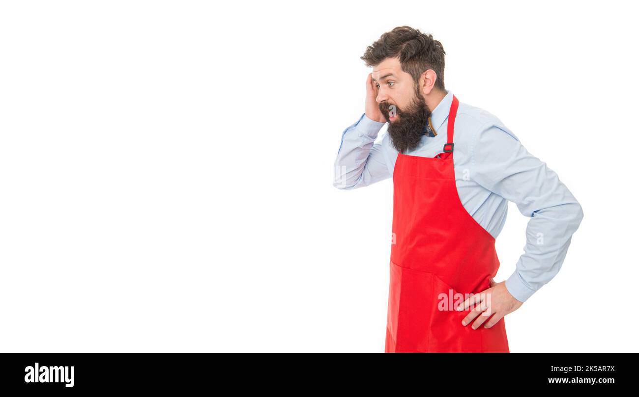 Despair professional business owner bartender grabbing head in desperation in red apron studio Stock Photo