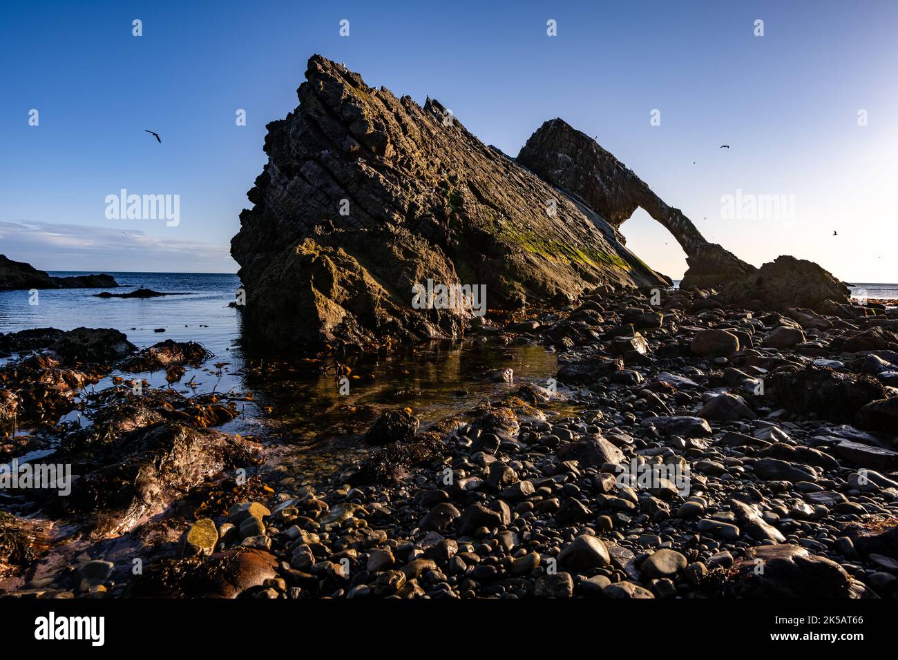 A scenic shot of Bow Fiddle rock in Buckie at sunrise, Scotland Stock Photo