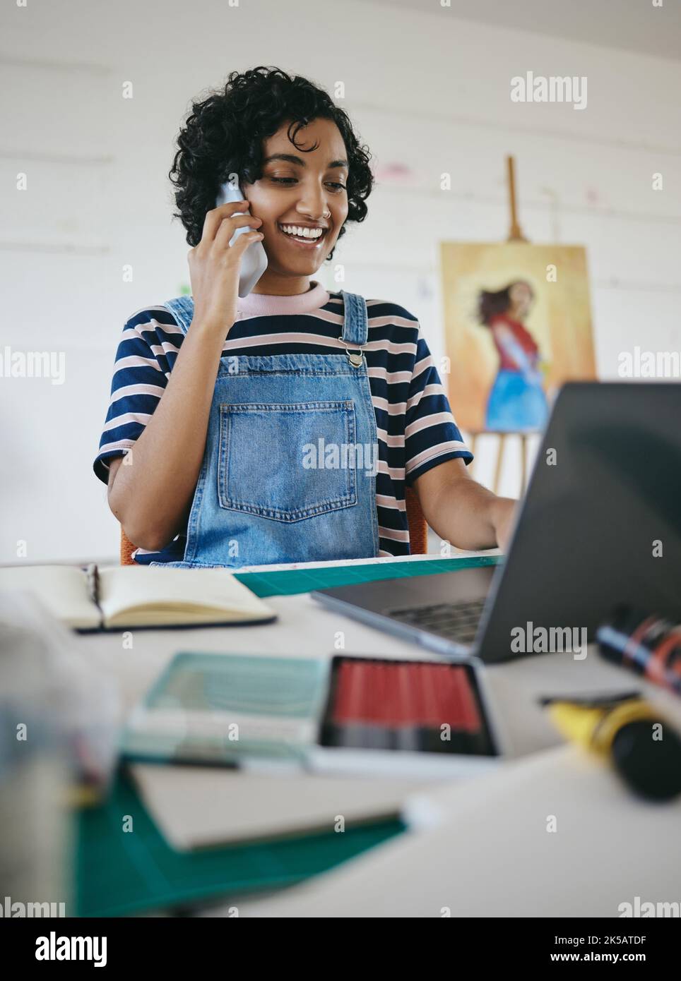 Laptop, woman and painter on a phone call about a painting offer from an art gallery, studio or artistic workshop. Smile, freelancer and happy girl Stock Photo