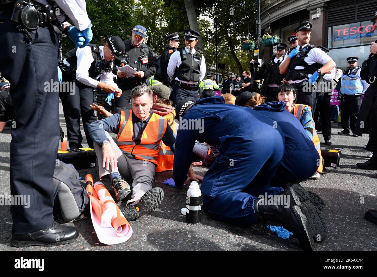 An activist glued his hand to the asphalt. Just Stop Oil Protest, Trafalgar Square, London. UK