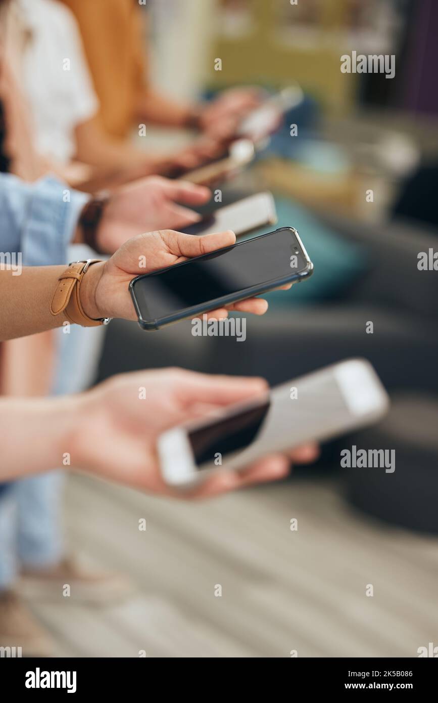 Social media, hands and row of smartphone people for internet app communication or wifi streaming. Phone consumer group holding device for digital Stock Photo