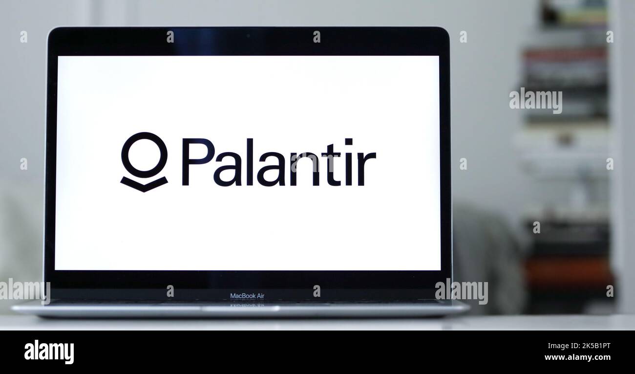 The logo of palantir displayed on the laptop screen a big data