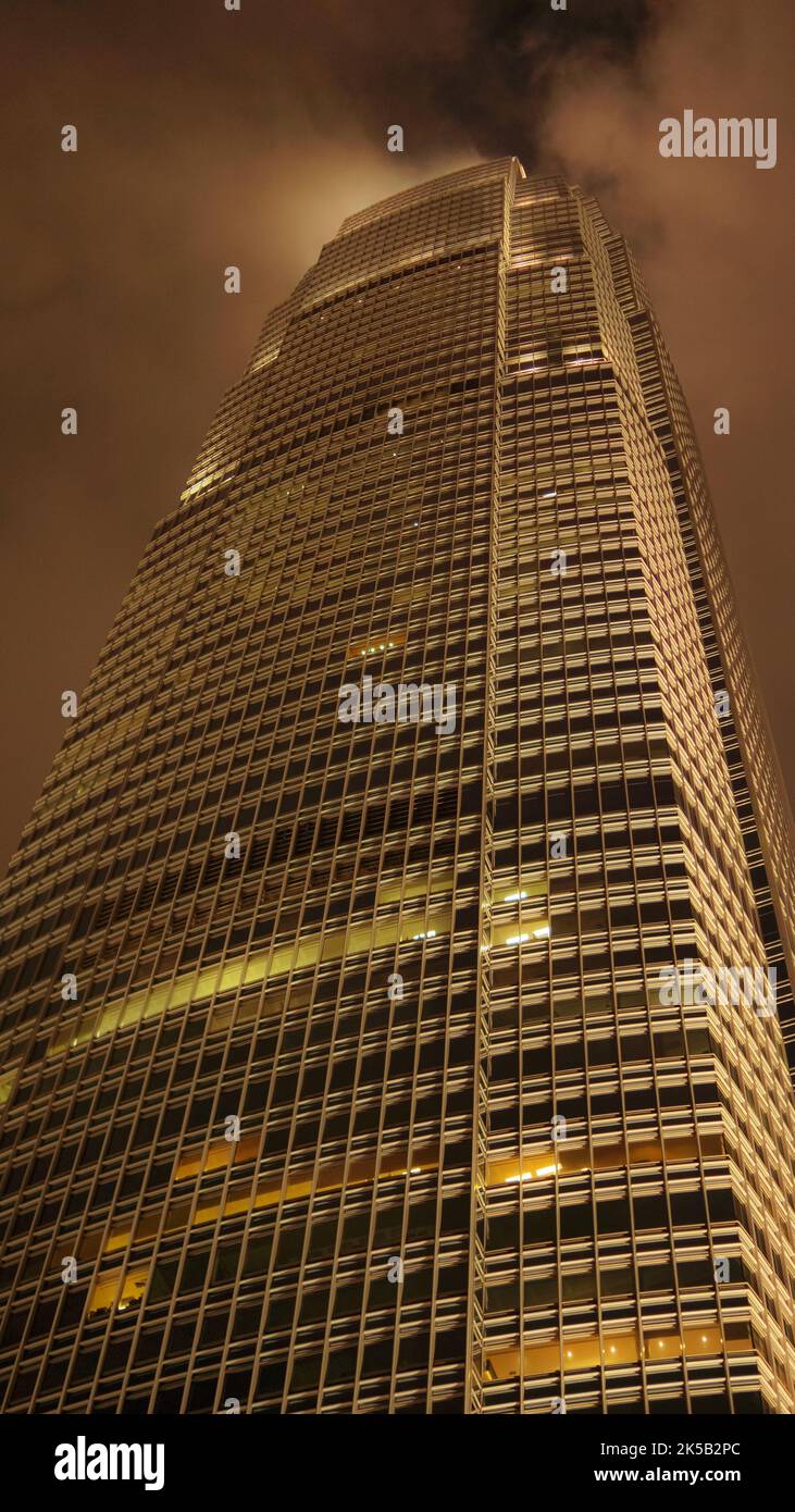 A low angle shot of a skyscraper under a cloudy sky Stock Photo