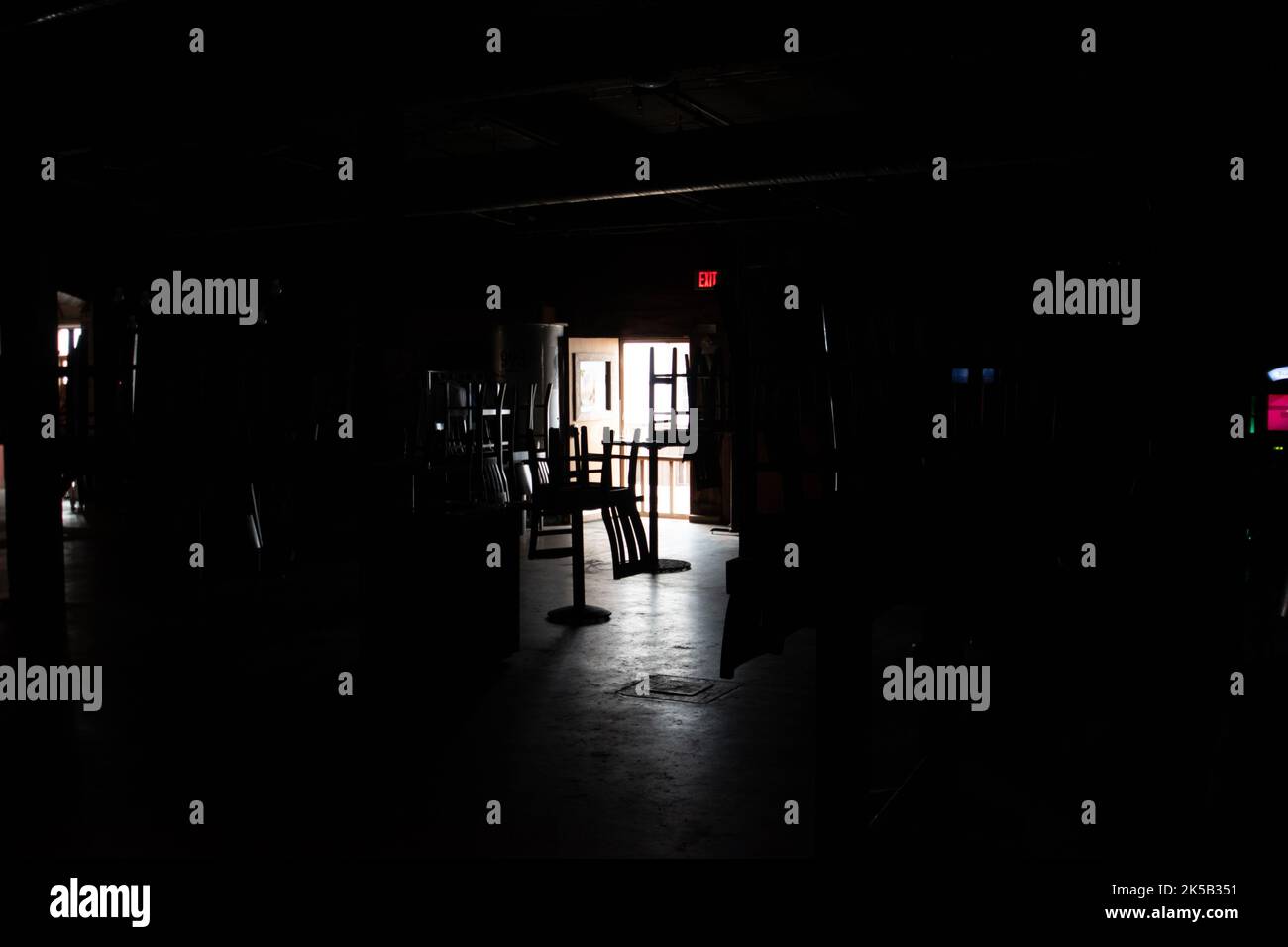 An interior of dark room with chairs and doors Stock Photo Alamy
