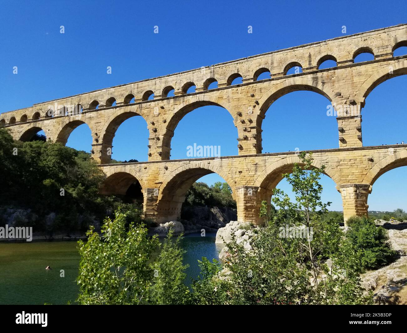 A scenic view of the Roman Aqueduct against a cloudless blue sky in ...