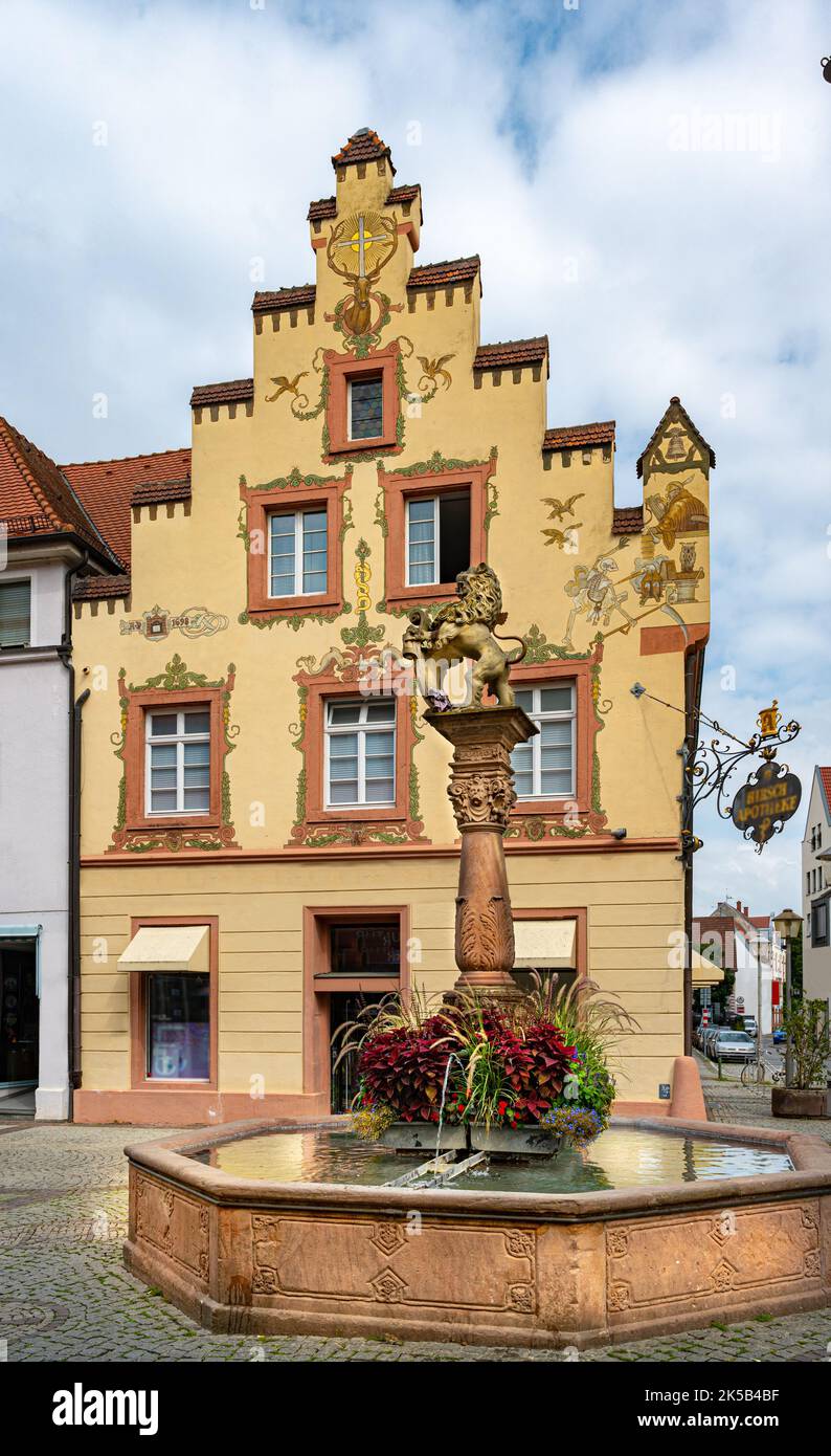 The lion fountain stands on the picturesque fish market in the heart of Offenburg in the background the historic building (1698) of the deer pharmacy. Stock Photo