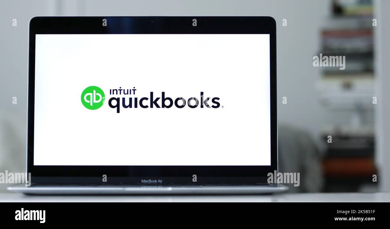 A laptop displays the logo of Quickbooks an accounting software program Stock Photo