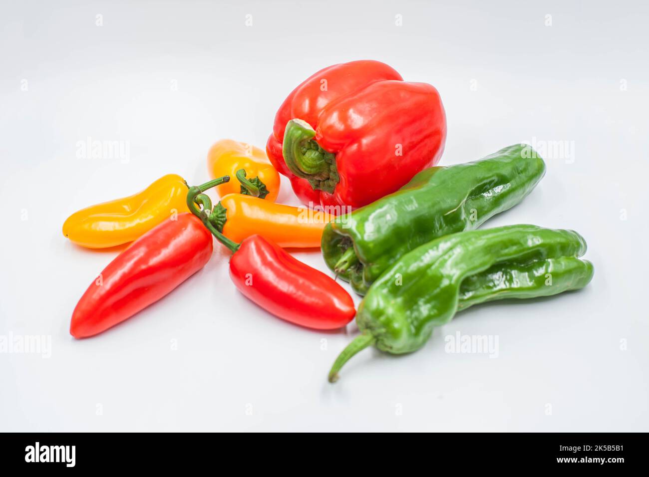 A green, red and yellow pepper isolated on white background Stock Photo ...