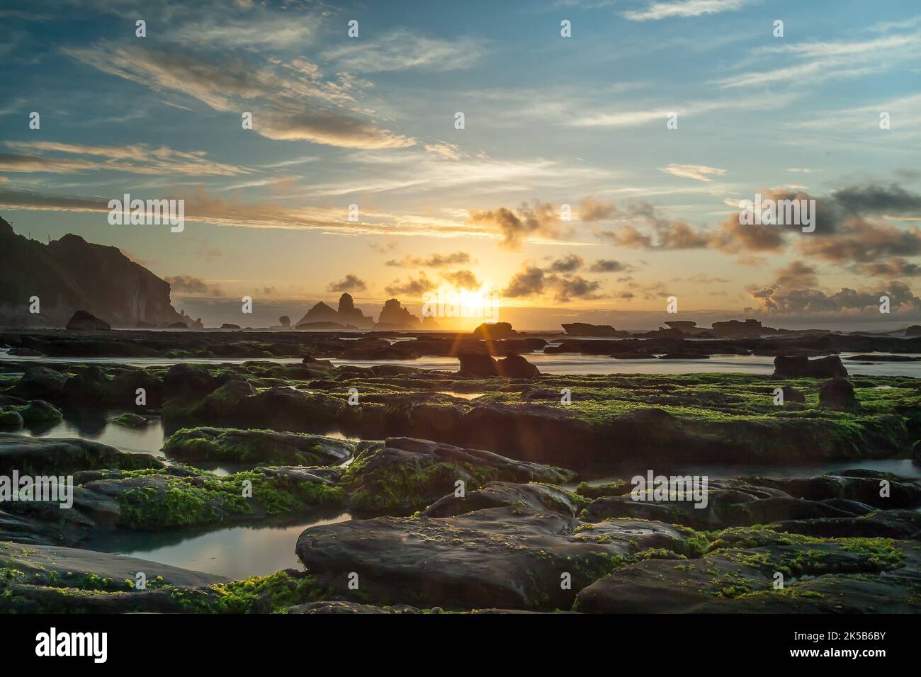 A breathtaking view of sunset clouds over Motukiekie Beach in Barrytown
